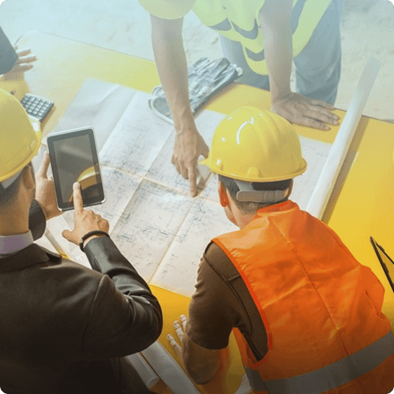 Home builder and architect reviewing approved plans