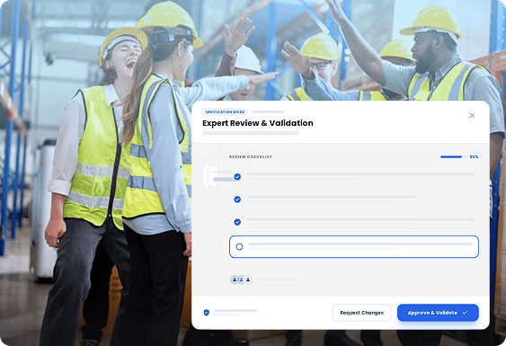 Construction workers in hard hats collaborating over a large expert review UI dashboard